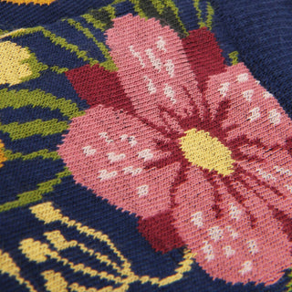Close-up of a floral patterned fabric with pink flowers on a dark blue background