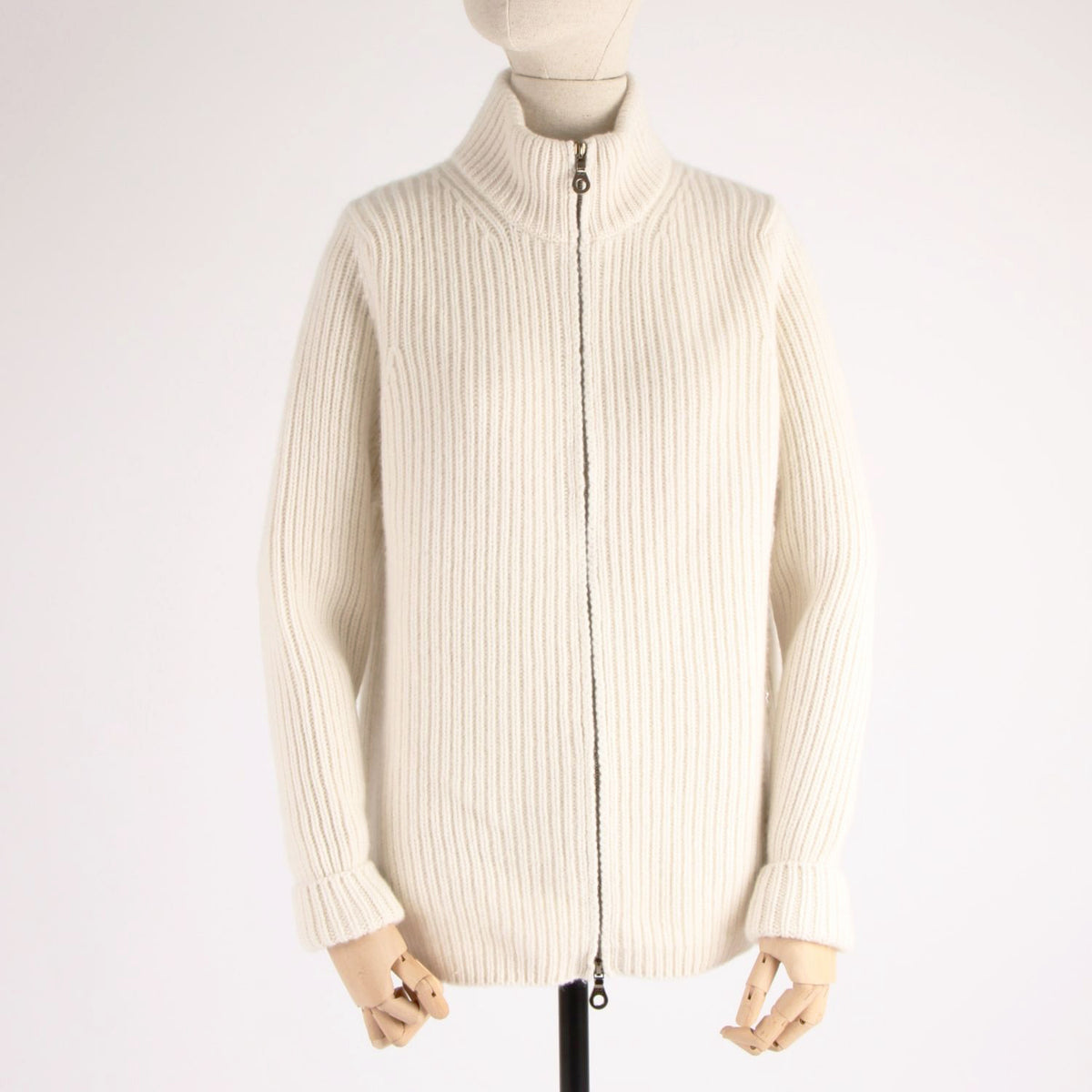 White ribbed knit cardigan on a mannequin against a white background