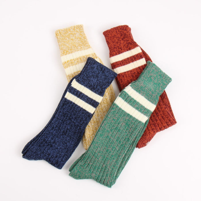 Four pairs of colorful striped socks on a white background