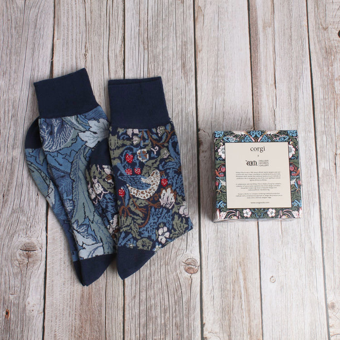2 pairs of William Morris socks with a gift box on a wooden background