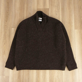 Brown sweater on a wooden surface