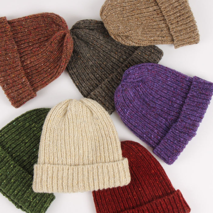 Collection of knit hats in various colors on a white background