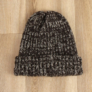 Knitted beanie on a wooden surface