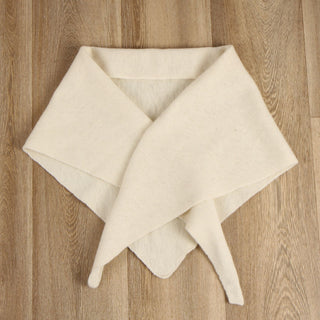 cream triangle scarf folded on a wooden surface