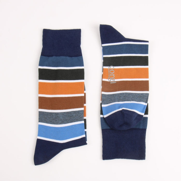 Two striped socks in blue with a flash of ochre photographed on a white background