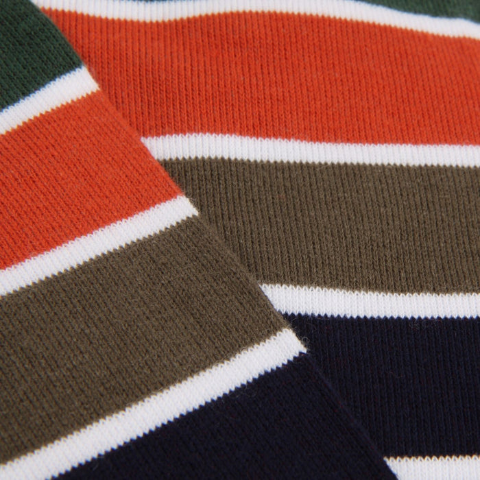 Close-up of a striped fabric with red, green, brown, and navy colors.