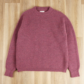 dusty pink crew pullover on a wooden surface