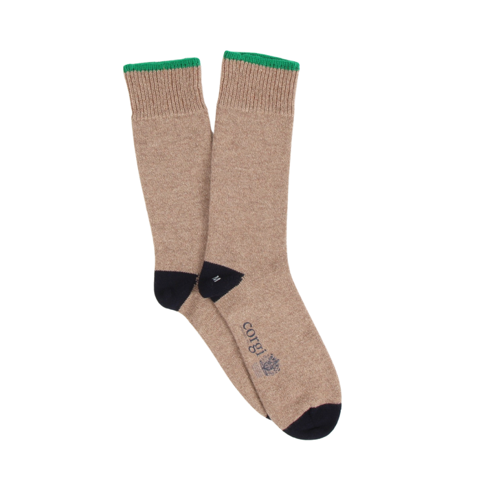 Pair of beige socks with green top and navy toes and heels on a white background