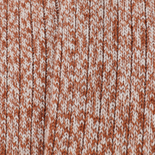 Close-up of a knitted fabric with a brown and white pattern