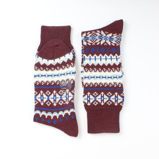 Pair of maroon socks with white and blue pattern on a white background