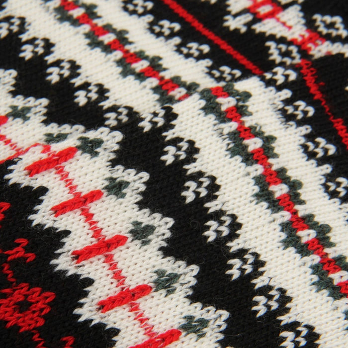 Close-up of a knitted fabric with black, white, and red pattern