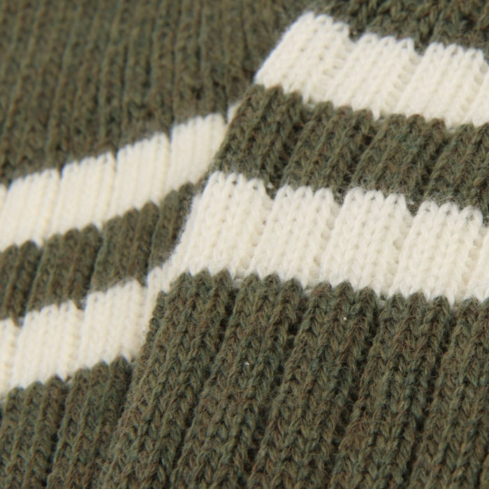 Close-up of a knitted fabric with green and white stripes