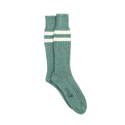 Green sock with white stripes photographed on a white background