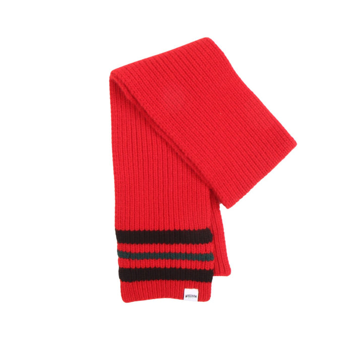 Red knitted scarf with black stripes on a white background
