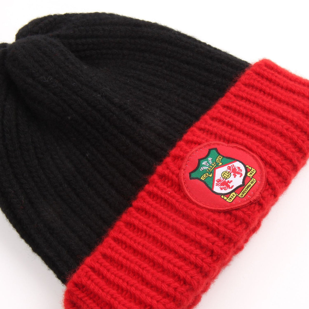 Black and red beanie with a logo patch on a white background