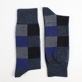 Pair of checkered socks with blue, gray, and black pattern on a white background