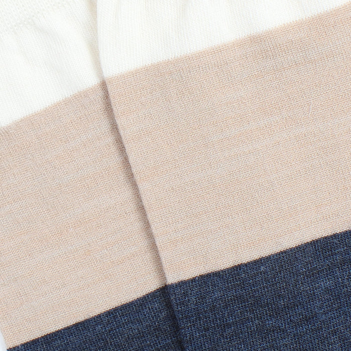 Close-up of the sock fabric with beige and blue stripes