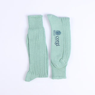 Pair of green ribbed socks on a white background with Corgi branding
