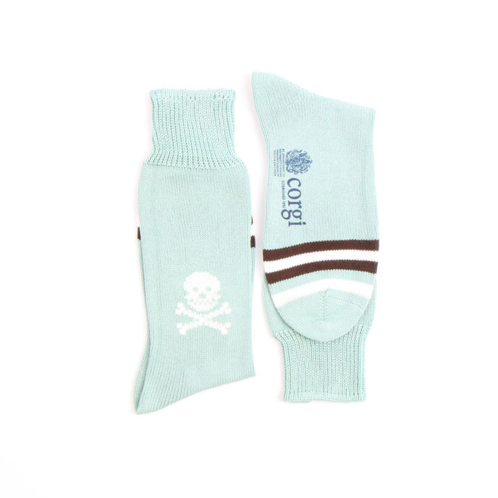Two light aqua socks with a skull design and 'corgi' branding on a white background