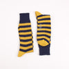 Pair of navy and yellow striped socks on a white background