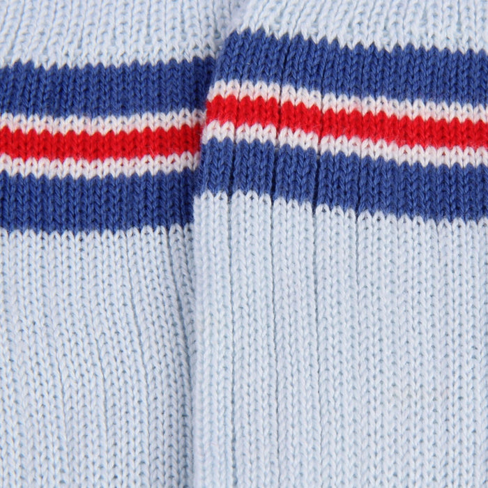 Close-up of a sock with blue, red, and white stripes