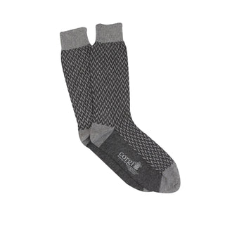 A pair of men's formal socks with a geometric pattern in silver and charcoal colors on a white background