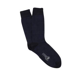 A pair of men's formal woven check cotton socks in navy and blue on a white background,