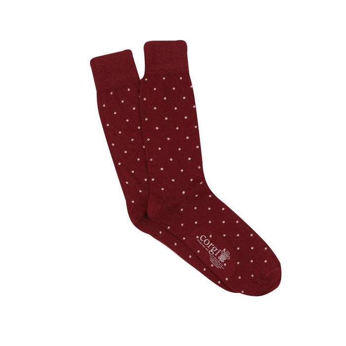 Maroon socks with white polka dots on a white background