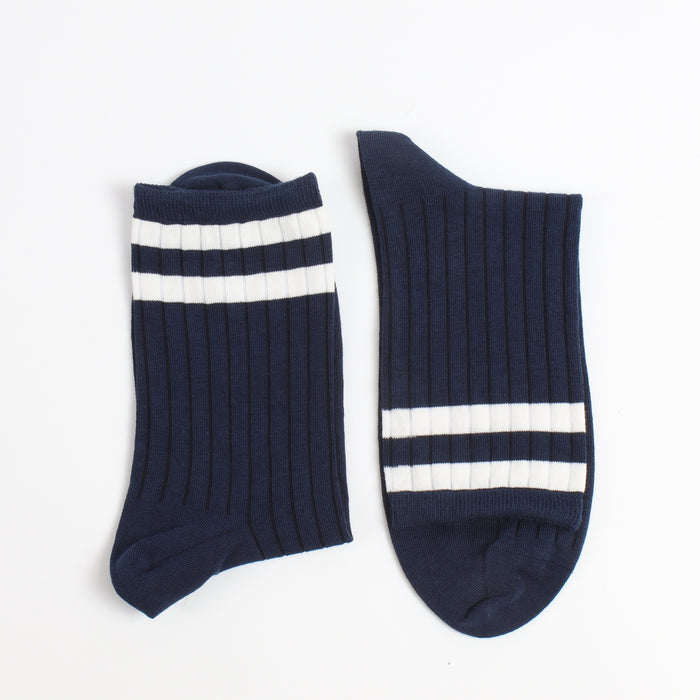 Navy blue socks with two white stripes on  the top end of the sock photographed on a white background
