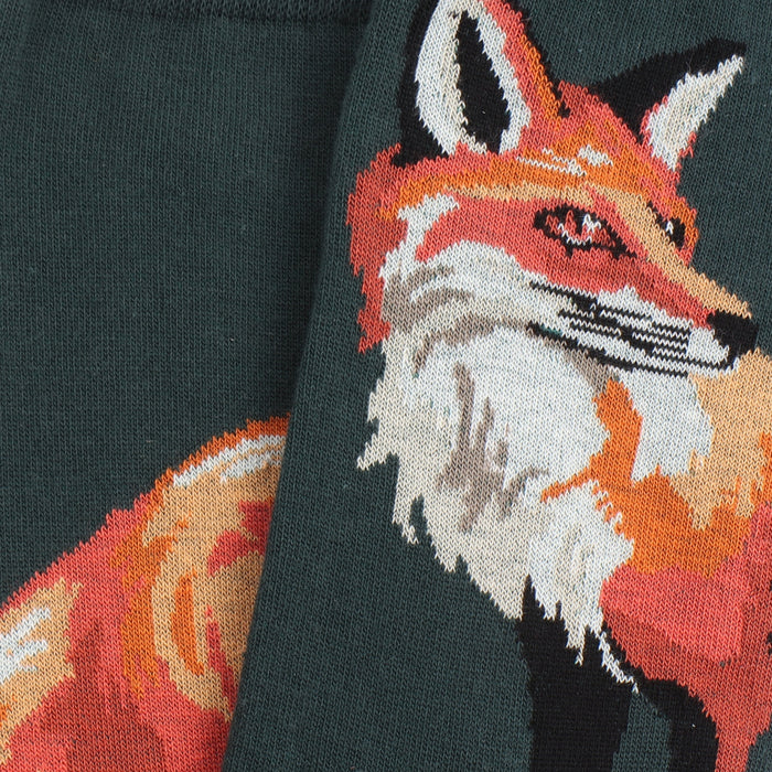 Intarsia fox design on a green fabric background