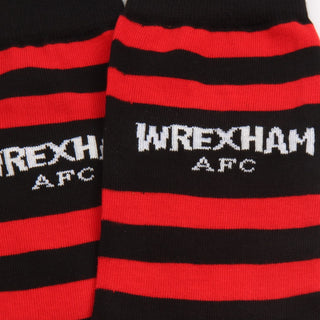 Black and red striped socks with 'Wrexham AFC' text on a close-up view.