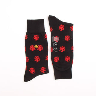 Black socks with red dragon patterns on a white background
