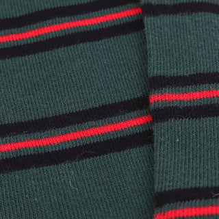 Close-up of green socks with red and black stripes