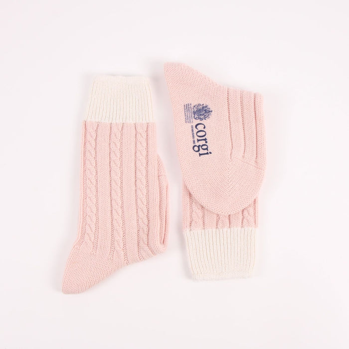 Pair of pink and cream socks with a visible brand logo on a white background