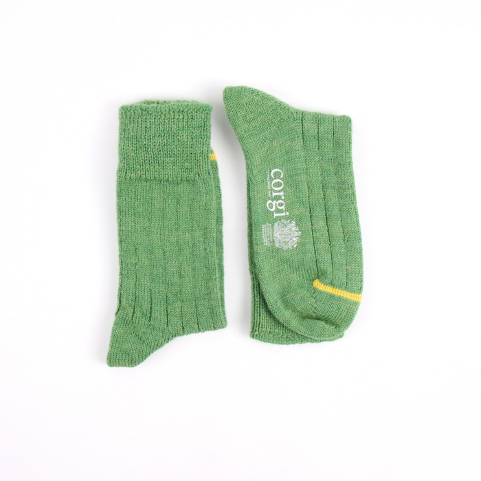 Green socks with a brand logo on a white background