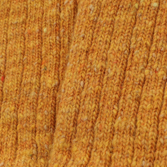 Close-up of textured mustard wool fabric