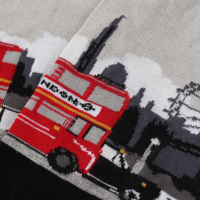 Close up image of a pair of women's socks with a London theme, featuring a red double decker bus on a black and silver background.