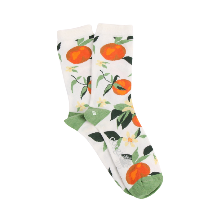 Pair of socks with oranges and a leaf pattern on a white background