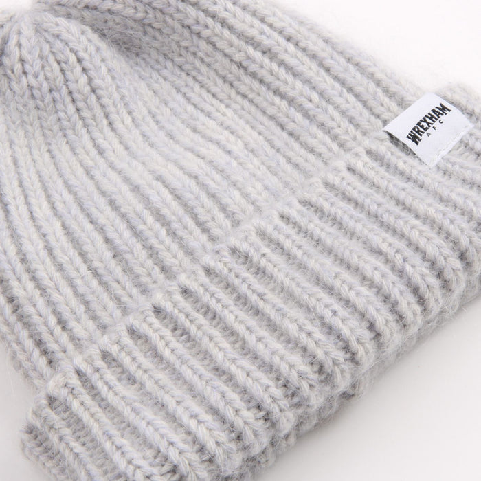 Grey knit beanie with a brand label on a white background