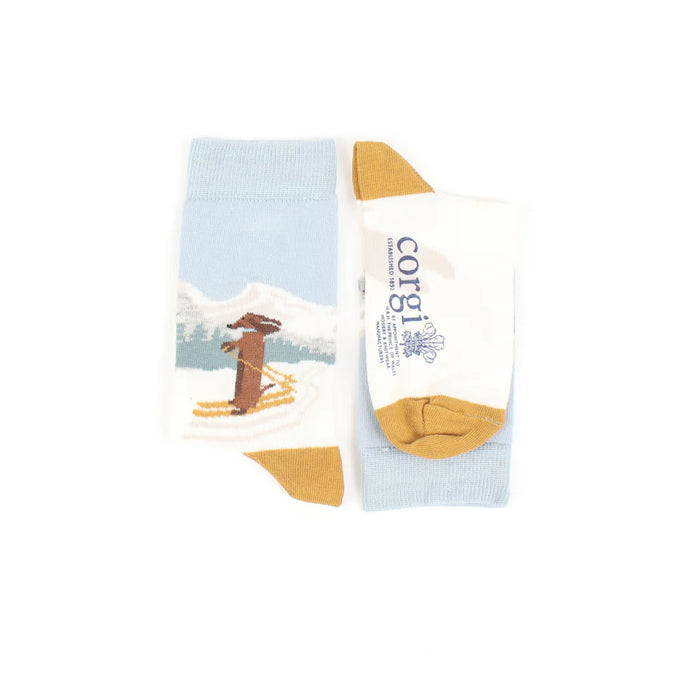 Knitted sock with a dachshund design on a blue background