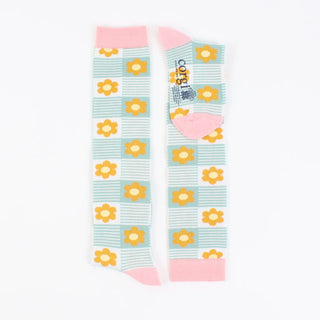 A pair of kids' knee-high socks with a floral pattern in pink and aqua green colours.