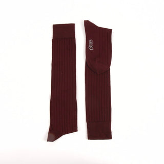 Pair of wine knee-high socks on a white background