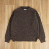 Brown knitted sweater on a wooden floor