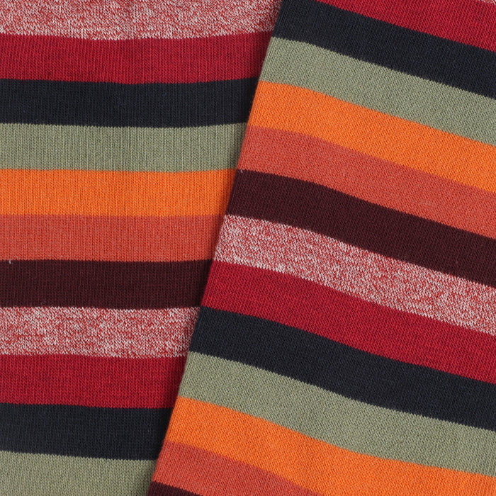Close-up of striped fabric with red, green, orange, and black colors.