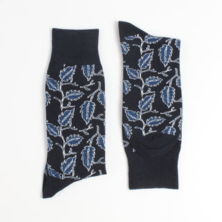 Black socks with blue leaf pattern on a white background