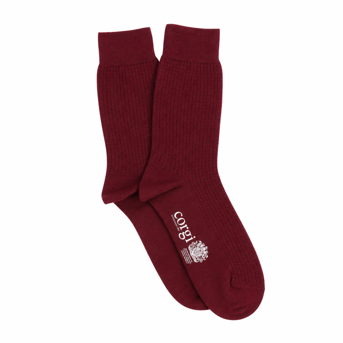 A pair of textured crew socks in maroon with a white printed logo on the sole, displayed against a plain white background.