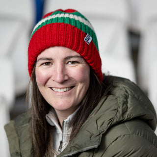 Woman wearing the red wall beanie hat.