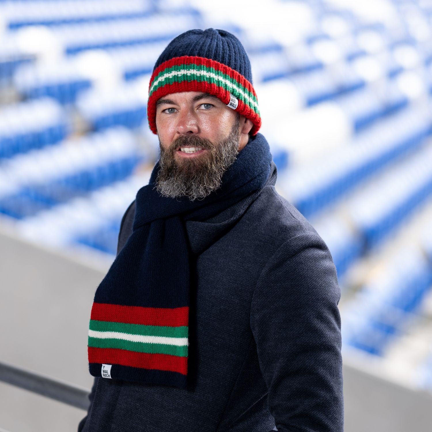 Red Wall hat and scarf being worn on the stands.