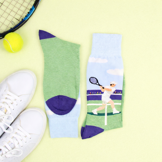 Tennis-themed socks with a player design, tennis racket, and ball on a light green background
