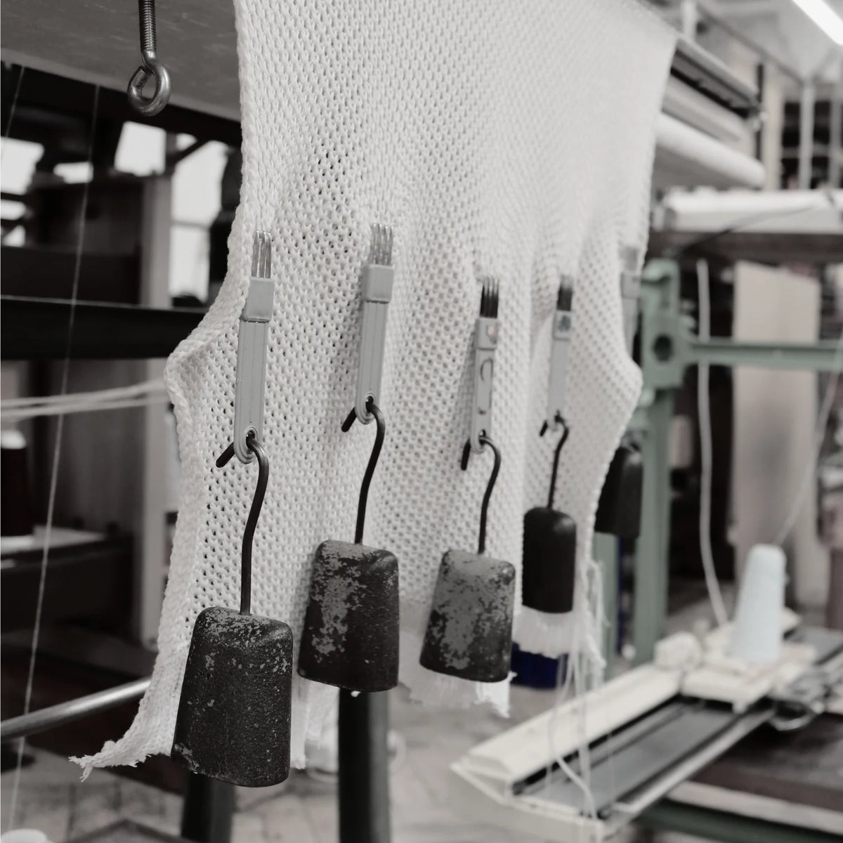 Textile production process with fabric and machinery in a factory setting